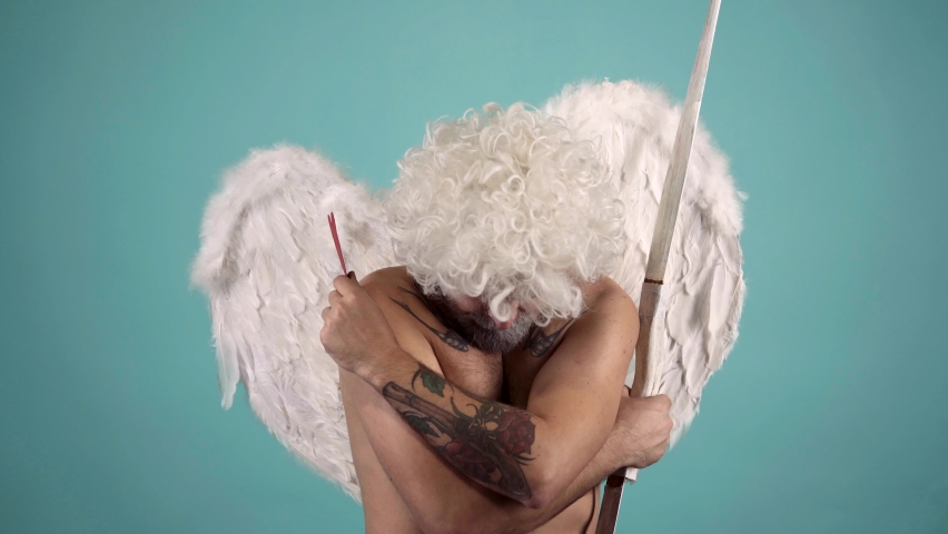 Valentin with heart. Funny crazy man with feathers wings of Cupid Valentines Day. Valentines day celebration. Funny valentines day concept. Royalty-Free Stock Footage #1085214488