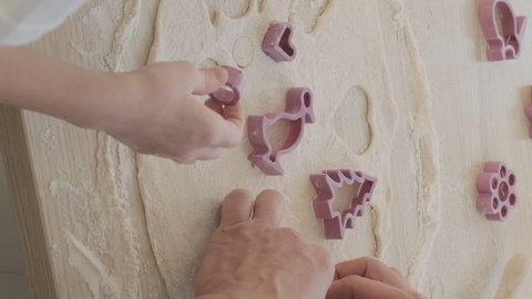Vertical Video. Little Girl with Father Cutting cookies of Dough and Putting it on a Baking Sheet