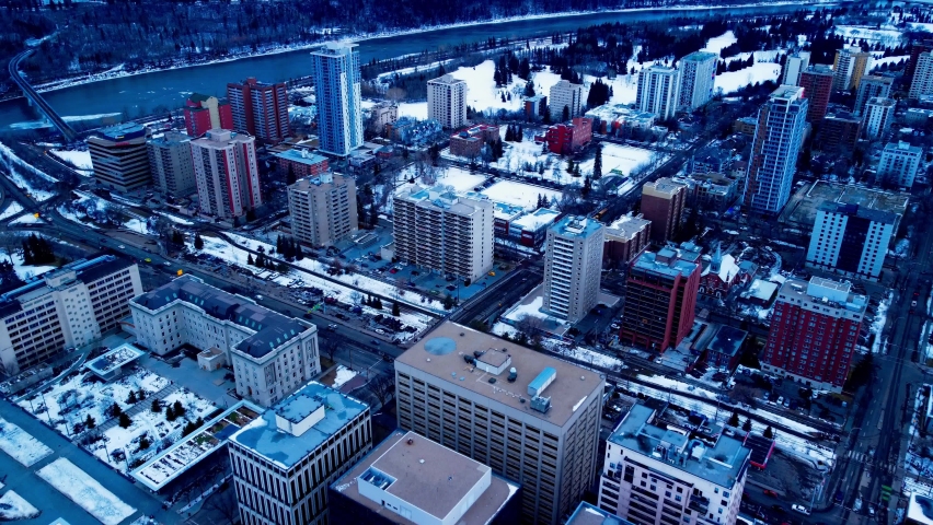 Edmonton 109 St NW and 99 Ave flyover winter snow covered Government and Residential buildings overlooking the downtown city headed South West towards Victoria Valley Park and curvy river university
