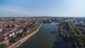Establishing Aerial View Shot of Toulouse Fr, Haute-Garonne, France, day revealing famous Bridge Saint-Michel