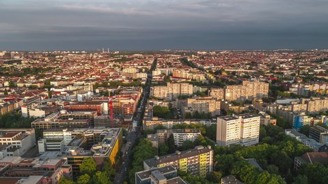 Establishing Aerial View Shot of Berlin, Germany, capital city, Kreuzberg, sun setting and storm on the horizon