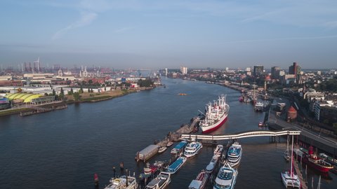 Hamburg, Germany - circa 2021 - Establishing Aerial View Shot of Hamburg De, Mecklenburg-Western Pomerania, Germany, day, port, Elbe river, crane rise uop shot