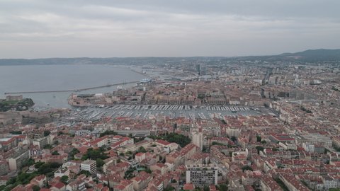 Establishing Aerial View Shot of Marseille Fr, Bouches-du-Rhone, Provence-Alpes-Cote d'Azur, France, overcast, port push into