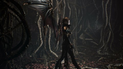 A beautiful cruel vampire walks through her ancient dungeon past creepy and unusual creatures. The concept of ancient Gothic violent vampires. The woman was created using 3D computer graphics.