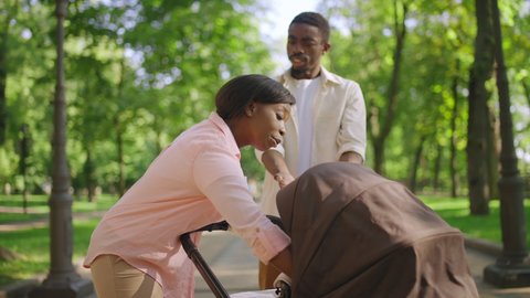 African American couple having argument about parenting while walking in park