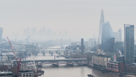 Mist and Fog in city, Establishing Aerial View Shot of London UK, United Kingdom, Thames River, skyscrapers