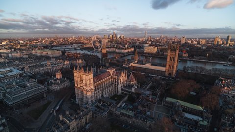 Establishing Aerial View Shot of London UK, United Kingdom, late sunset, city center, Big Ben, Westminster Parliament, Westminster Abbey, city skyline, push in