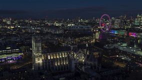 Establishing Aerial View Shot of London UK, United Kingdom, evening night, city center, Big Ben, Westminster Parliament, Westminster Abbey, city skyline, Parliament Square Garden, circling