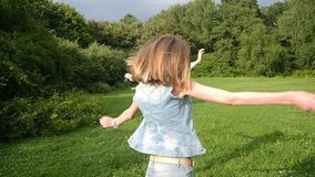 Three friends, young girls, having fun in park, running , jumping, doing cartwheels, slow motion.
