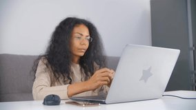 Video call and online teaching concept. Black woman talking on web camera with friendly smile. Happy African female speaking to the students over internet connection. Freelancer working from home