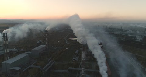 Aerial View Of High Smokestack With Smoke Emission. Plant Pipes Pollute Atmosphere. Industrial Factory Pollution, Smokestack Exhaust Gases. Industry Zone, Thick Smoke Plumes. Climate Change, Ecology