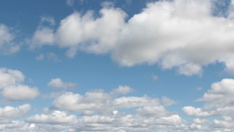 video clip features a time lapse of beautiful soft and white clouds on a blue summer sky 