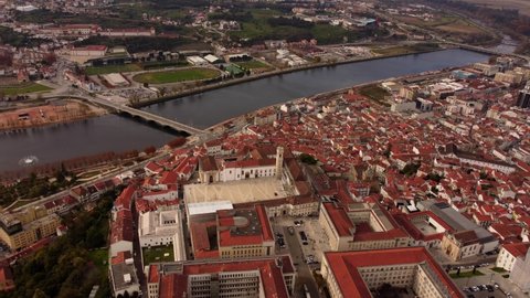 Aerial of coimbra university city town old historical center, drone fly above the cityscape during sunset