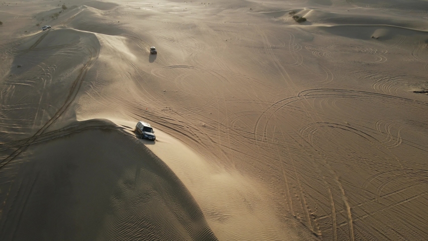 4K: Drone view of a 4x4 stuck in the sand during the desert safari in the Al Qudra desert of Dubai, United Arab Emirates
