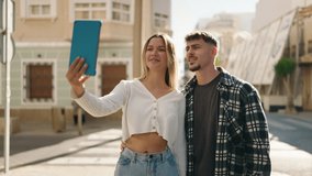 Young couple smiling confident having video call at street