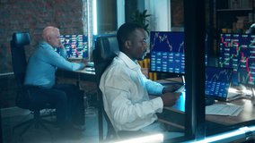 A team of stockbrokers are working in the office. Financial, investment, business concept. - Powered by Shutterstock - Get 15% off with code: PIKWIZARD15