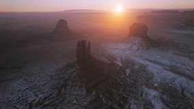 Epic golden sunrise glowing above Monument valley in nature Navajo Tribal park in Arizona USA. Aerial drone view of famous landmark from western movies, Hollywood filming location at winter 4K footage