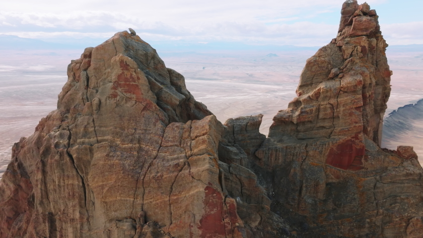 Aerial of The Edge of the World Shiprock is an unexpected and dramatic geological wonder in the rocky desert southwest of New Mexico, USA. 4K nature landscape with mountains on motion background