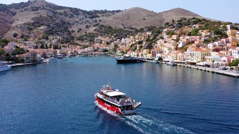 Symi, Greece - September 17, 2020:  Simi island harbor port, classical ship yachts,  Aegean Sea bay. Greece islands holidays vacation travel tours from Rhodos island. Symi, Greece,  Dodecanese.