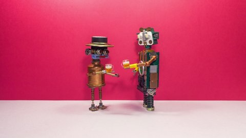 Meeting of friends. Two robots greet each other and drink beer, rejoicing at the meeting. Stop motion animation.