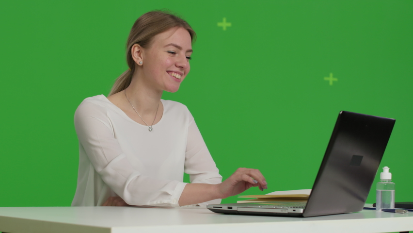 Business woman works with a computer at her deskover green screen . Remote work. Social distance. Girl studying. Female model blogging, communicating with clients or doctor or psychiatrist | Shutterstock HD Video #1085258828