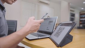 Young Asian male using smartphone scan qr code on the tablet screen registering for  membership online form, digital technology, easy convenience lifestyle multitask worker, online access service - Powered by Shutterstock - Get 15% off with code: PIKWIZARD15