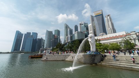 Singapore, Singapore - Feb 4, 2020: Time-lapse of tourist people walk at Merlion statue, Marina Bay. Asian tourism lifestyle, Asia city travel landmark, or traveler transportation concept