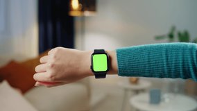 Woman using smartwatch with chroma key close-up. Young female person wearing fitness bracelet with green screen close-up. - Powered by Shutterstock - Get 15% off with code: PIKWIZARD15