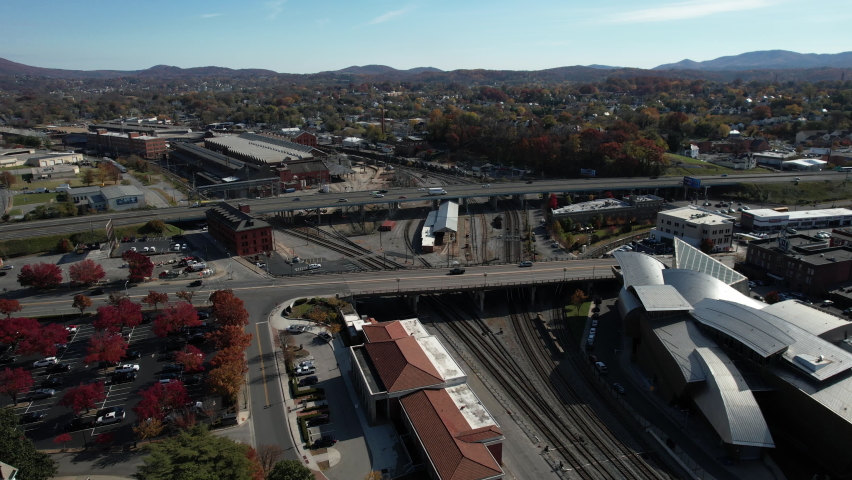 Aerial View of Roanoke, Virginia. Interstate 581 Highway Overpass Traffic Above Railroad and Cityscape on Sunny Autumn Day