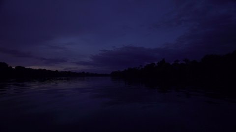 Night time pan shot across the Amazon river