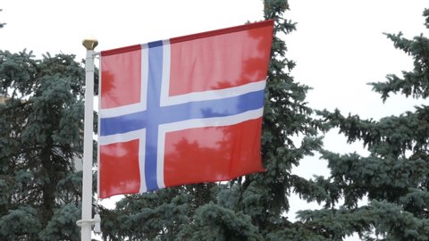 Ungraded: National flag of Norway on the flagpole. Norwegian official flag waving in the wind. Ungraded H.264 from camera without re-encoding.