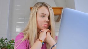 Sad white woman working on laptop at home during lockdown. Video portrait of stressed caucasian female trying to solve problem. Freelancer person stressing about work in 4k stock video