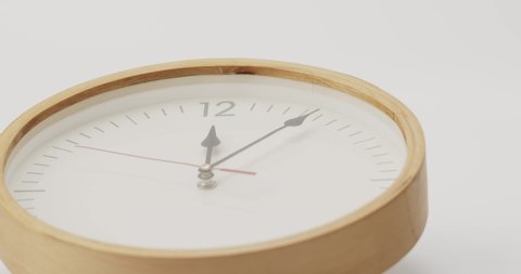 Zoom in wood wall clock tell the time 12 o'clock. It's time to take a break from work on white background.
