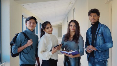 A group of Indian students with books and a tablet at the university or college. New modern fully functional educational institution. Education concept