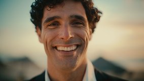 Close Up Portrait of a Happy Young Adult Male with Curly Hair and Brown Eyes Posing for Camera. Handsome Multiethnic Caucasian Male in a Suit Charmingly Smiling. Warm Color Edit. - Powered by Shutterstock - Get 15% off with code: PIKWIZARD15