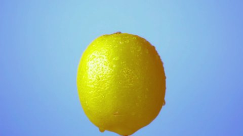 Lemon Rotating Lemons Splashing Blue Background Stock Footage Video ...