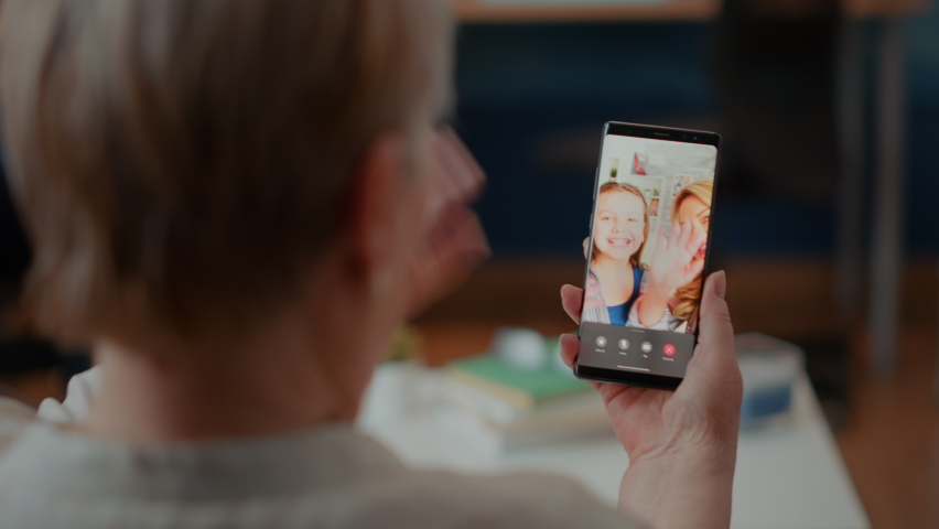 Elder woman calling family on online videoconference, enjoying chat with daughter and little girl. Retired adult talking to people on teleconference call for remote communication. Close up Royalty-Free Stock Footage #1085297546