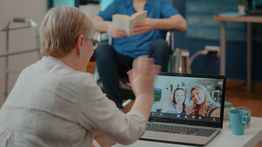 Elderly adult meeting with relatives on online videoconference. Senior woman using laptop with remote teleconference call to chat with daughter and little girl. Internet telecommunication Royalty-Free Stock Footage #1085297693