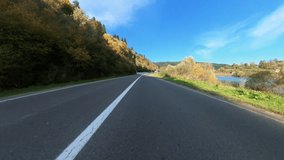 POV video biker riding motorcycle on empty beautiful country road. Shadow of motorcyclist riding alone to his destination. Motorcycling.