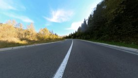 Wide-angle camera video of black professional biker motorcycling riding fast in countryside. Speed, motion and freedom. Roadtrip.