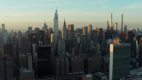 Slide and pan footage aerial of downtown skyscrapers at sunset. Chrysler building and One Vanderbilt. Manhattan, New York City, USA