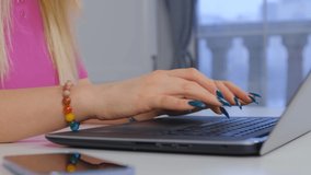 Freelancer woman with long nails typing on laptop computer at home during lockdown. Freelance writer working on notebook pc. 4k stock video of person doing distant work online with internet technology