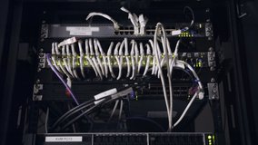 Close up shot of data servers with ethernet cables and blinking hard drive lights - Powered by Shutterstock - Get 15% off with code: PIKWIZARD15
