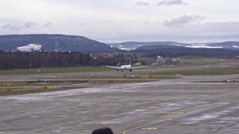 Swiss airplane Airbus A340 register HB-JHK taking off from Zürich Airport on a cloudy winter day. Movie shot January 8th, 2022, Zurich, Switzerland.