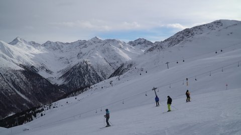 Livigno, Italy - December 29, 2021 - skiers and chairlifts on the slopes of Livigno
