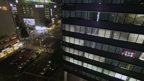 Nagoya.Japan-October 31.2019: View of the streets of Nagoya Japan from an apartment. Busy metropolitan traffic. Alot of people. Nighttime. Timelapse. Camera slowly zooming out.