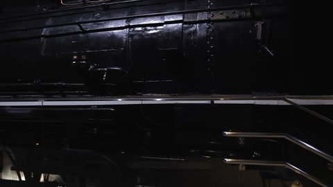 Nagoya.Japan-October 31.2019: Vintage locomotive at a railway museum in Nagoya Japan. Old transportation technology. Steam engine. Camera slowly turning left.