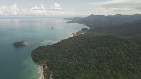 aerial slow dolly view of Tropical island with jungle beach and tourism village on Koh Chang