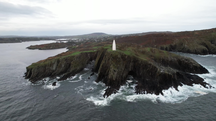 Aerial View of Baltimore Beacon on Coast of County Cork, Ireland. Stone Tower on Clifftop Above Waves of Atlantic Ocean