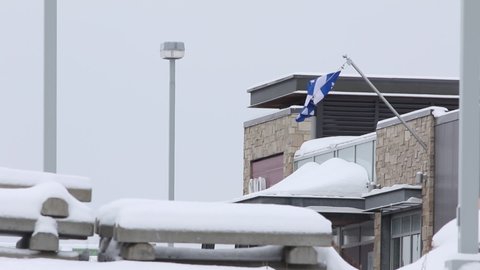 Quebec, Canada - 01-13-2022: a Quebec flag on a building